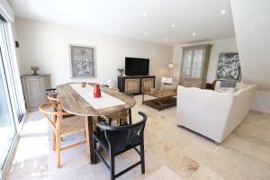 a living room with a table and chairs and a couch at charming house with private pool in the heart of the village of aureille in the alpilles, 6 people. in Aureille