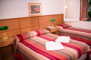 Un pat sau paturi într-o cameră la Hotel Roosevelt