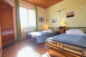 a bedroom with two beds and a window at pretty detached villa with private swimming pool, in Aureille, in the alpilles - 8 people in Aureille +35 photos