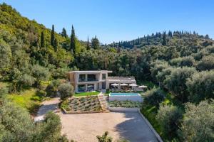an aerial view of a house in the hills at Villa Optima by Villa Plus in Peroúlion