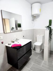 a bathroom with a sink and a toilet at Fantastic Holiday Apartment in Arona