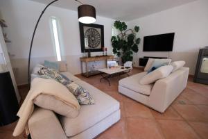 a living room with two couches and a tv at Air-conditioned villa with heated pool, Luberon, in Puget - 10 people in Puget