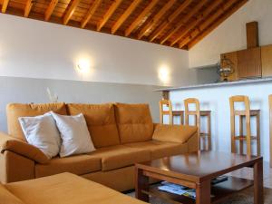 a living room with a couch and a table at Atlantis Breeze in Madalena