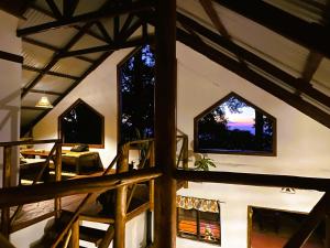 a view of a room with two windows in a building at Villa Kinyonga, Camp Mawingu in Muheza