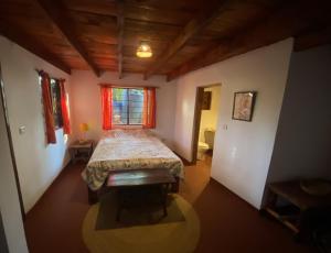 a bedroom with a bed in a room with a window at Villa Kinyonga, Camp Mawingu in Muheza