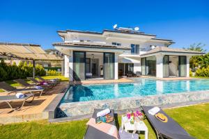 a villa with a swimming pool and a house at Villa White Cloud in Dalyan