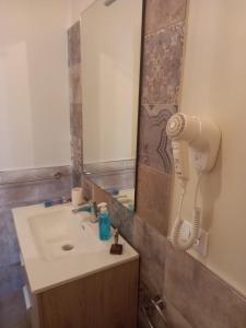 a bathroom with a sink and a blow dryer at Casa Rosina in San Vito lo Capo +47 photos