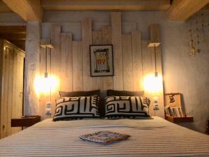 a bedroom with a large bed with two lamps at La grotte du pèlerin - Appartement semi-troglodyte in Saintes