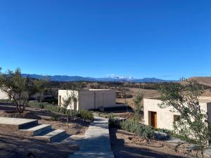 a path leading to a building in the desert at TOUGYA Ecolodge Near Agafay Desert in Marrakesh
