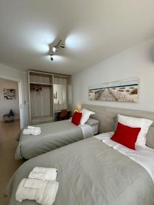 two beds in a hotel room with red pillows at Magical Andalusian Vacation "Los Arcos" in Tózar +36 photos