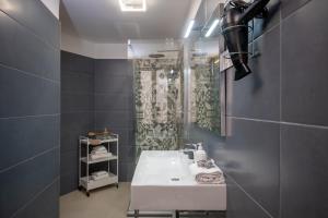 a bathroom with a white sink and a shower at RomAntica Bocca della Verità in Rome +65 photos