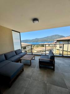 a living room with couches and a view of the ocean at Magnifique appart T3 vue mer in Propriano