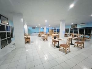 a dining room with tables and chairs in a building at LeCansado in Nouadhibou +7 photos