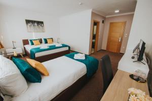 Rúm í herbergi á Hotel Brcko Gas Doboj