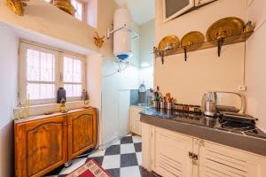 a kitchen with wooden cabinets and a checkered floor at Dar Noubti in Marrakech