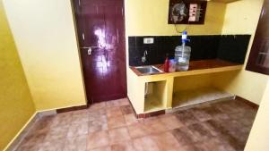 a small bathroom with a sink and a counter at Thiru Arunesha Family Home Stay Tiruvannamalai in Tiruvannāmalai