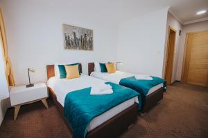 Rúm í herbergi á Hotel Brcko Gas Doboj