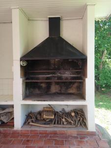 an outdoor oven with a pile of wood at Bayas Coloradas, San Lorenzo, Salta in San Lorenzo