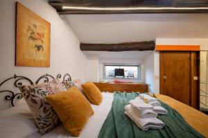 a bedroom with a bed with towels on it at RomAntica Bocca della Verità in Rome