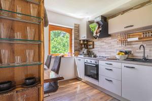 a kitchen with white cabinets and a sink and a window at Holiday home in Trebnje Kranjska Krain 42897 in Trebnje