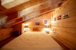 a large wooden room with two lamps in it at Authentique chalet montagnard in Isola 2000