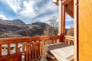 a porch of a cabin with a bench on it at Authentique chalet montagnard in Isola 2000