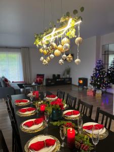 a dining room table with a christmas tree in the background at Vila Trakai in Trakai