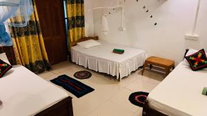 Letto o letti in una camera di Sigiri KP Family Home