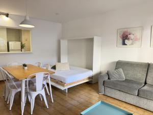 ein Wohnzimmer mit einem Bett, einem Tisch und einem Sofa in der Unterkunft Agi Sant Jordi in Roses