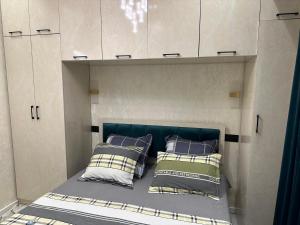 a bed in a cabinet with two pillows at Garden - Apartment hotels in Tashkent