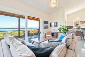 a living room with a couch and a table at Villa Marathi with stunning ocean view in Chania Town
