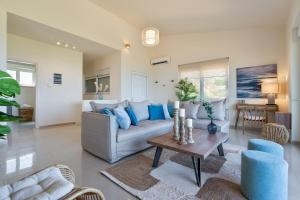 a living room with a couch and a table at Villa Marathi with stunning ocean view in Chania Town