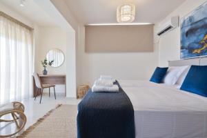 a bedroom with a large bed and a desk at Villa Marathi with stunning ocean view in Chania Town