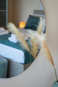 a mirror reflection of a bedroom with a bed at Villa Marathi with stunning ocean view in Chania Town