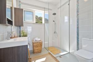 a bathroom with a shower and a toilet and a sink at Villa Marathi with stunning ocean view in Chania Town