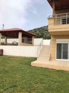 a house with a staircase leading to a building at Villa Marathi with stunning ocean view in Chania Town