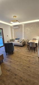 a living room with a couch and a table and chairs at Stela in Herceg-Novi