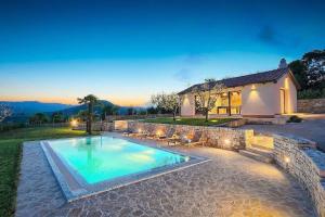 a swimming pool in front of a house at Villa Analucija I by Istrialux in Potpićan