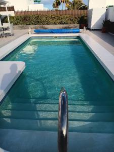 a swimming pool with a black object in the water at Casa Jaime in Puerto del Carmen