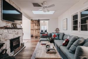 a living room with a couch and a fireplace at Lola Cottage in Adaminaby