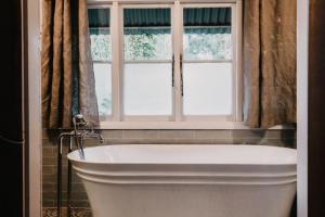 a bath tub in a bathroom with a window at Lola Cottage in Adaminaby +16 photos
