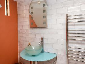 a bathroom with a bowl sink and a mirror at The Grottoes in Torquay +66 photos