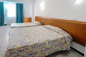 A bed or beds in a room at Hotel Amic Can Pastilla