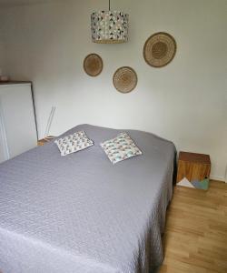 a bedroom with a bed with two pillows on it at Les 6 chemins in Saint-Nazaire
