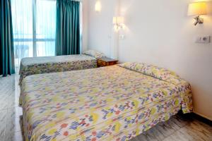 A bed or beds in a room at Hotel Amic Can Pastilla