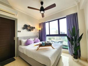a bedroom with a bed with a ceiling fan and a window at Cozy Loft Suite 2BR near JB CIQ 7Pax in Johor Bahru +111 photos