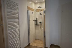 a bathroom with a shower and a shower stall at Bei den Beckers in Weitenhagen +26 photos