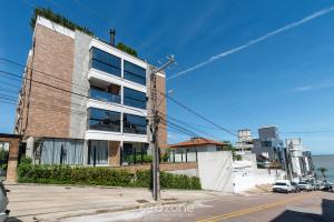 an apartment building on the side of a street at Studio Charmoso apenas 200m da Praia - PMO0404 in Florianópolis
