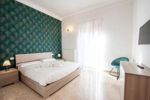 En eller flere senge i et værelse på Appartamenti Ferdi - Trilocale o Mansarda