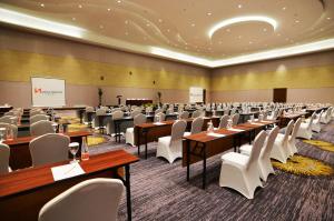 a conference room with tables and white chairs at Swiss-Belhotel Cirebon in Cirebon +52 photos